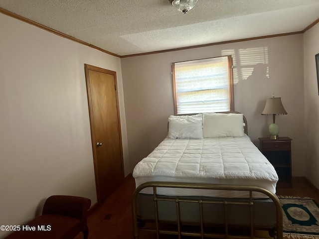 bedroom featuring a textured ceiling and crown molding