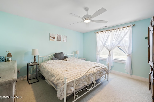 bedroom with ceiling fan and light carpet