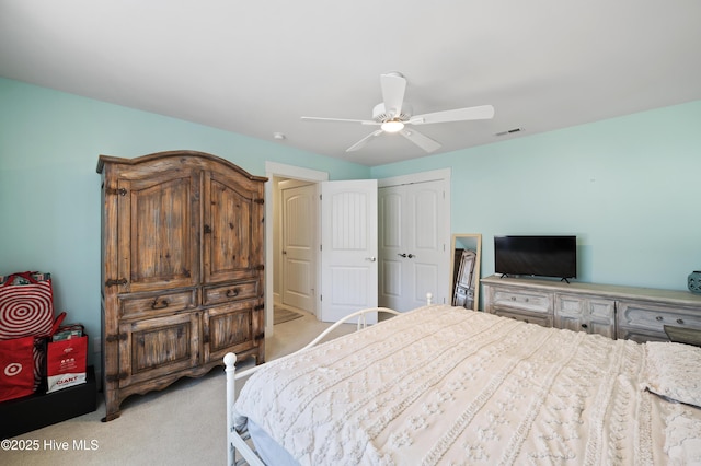 carpeted bedroom with ceiling fan and a closet