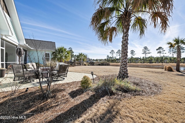 view of yard featuring a rural view and a patio area