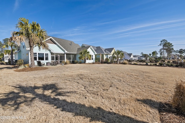 rear view of house with a lawn