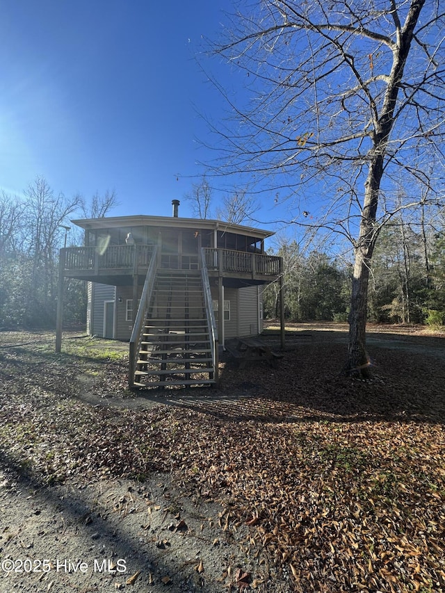 back of house with a wooden deck