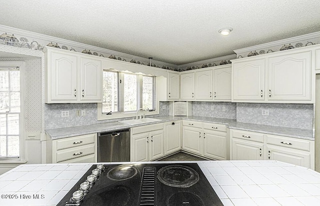 kitchen featuring tile countertops, stainless steel dishwasher, white cabinetry, and sink