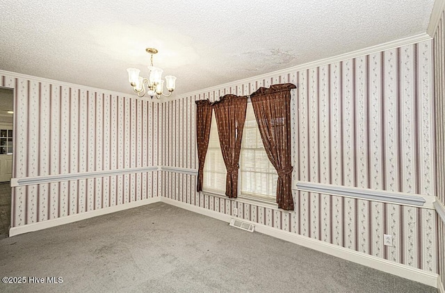 carpeted empty room featuring a chandelier, a textured ceiling, and crown molding