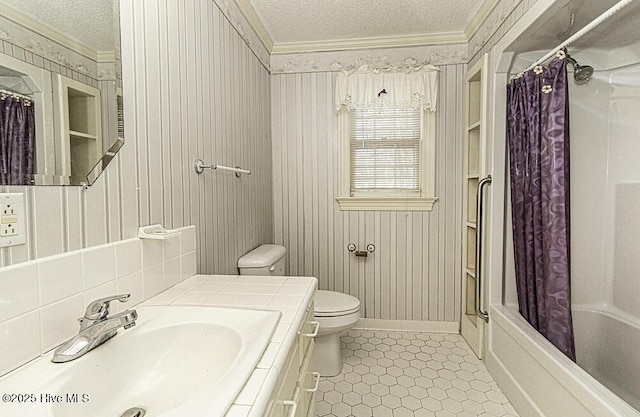 full bathroom featuring crown molding, shower / bath combination with curtain, a textured ceiling, toilet, and vanity