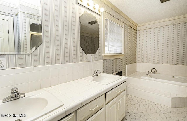 bathroom featuring vanity, tile patterned floors, a relaxing tiled tub, ornamental molding, and a textured ceiling