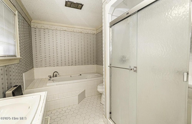 full bathroom featuring tile patterned floors, a textured ceiling, toilet, vanity, and ornamental molding