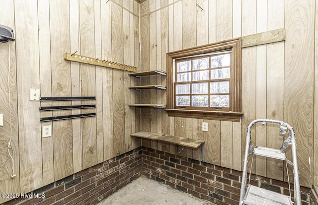 room details featuring concrete flooring and wooden walls