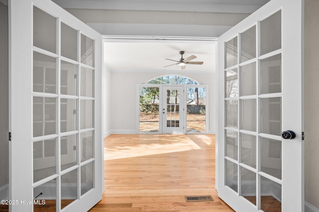 doorway to outside with crown molding, ceiling fan, french doors, and hardwood / wood-style floors