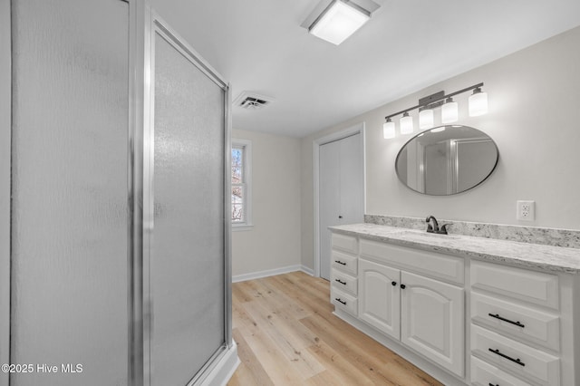 bathroom featuring vanity and hardwood / wood-style flooring