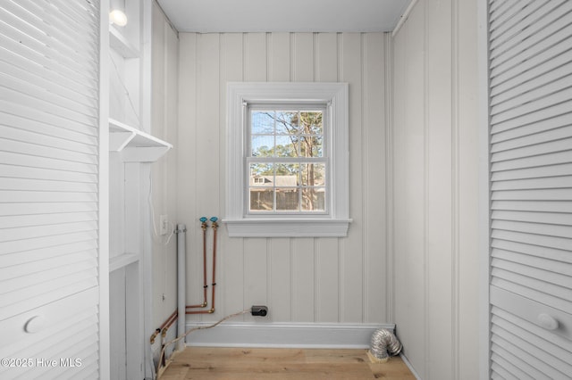 clothes washing area featuring light wood-type flooring