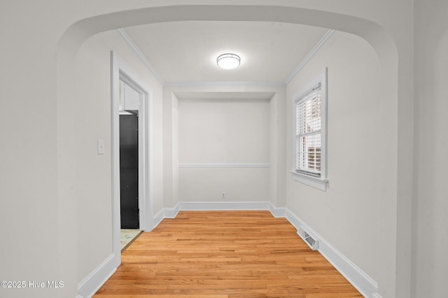 corridor featuring hardwood / wood-style floors and ornamental molding