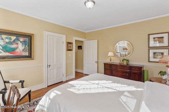 bedroom with light hardwood / wood-style flooring and ornamental molding