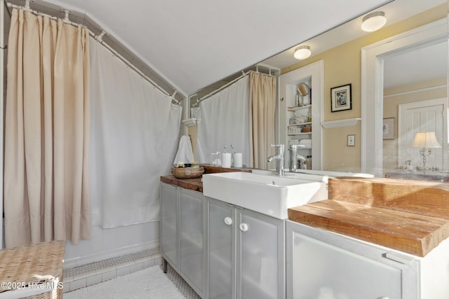 bathroom featuring vanity, curtained shower, and tile patterned floors