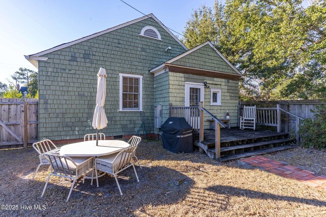 back of house featuring a deck