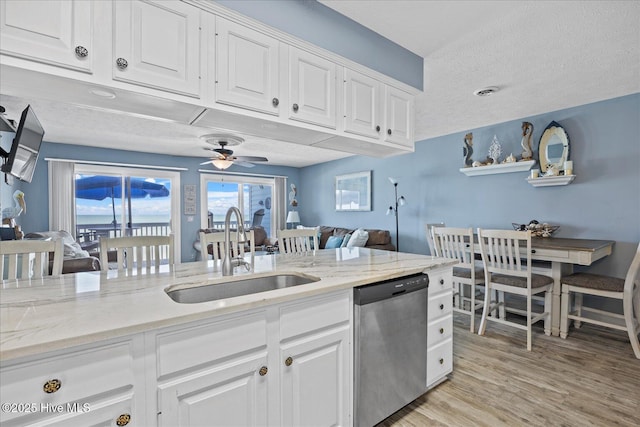 kitchen featuring ceiling fan, sink, white cabinets, and stainless steel dishwasher