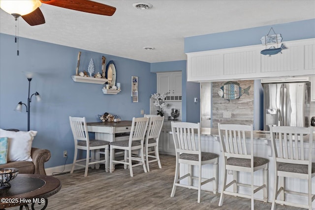 dining room with ceiling fan and wood-type flooring