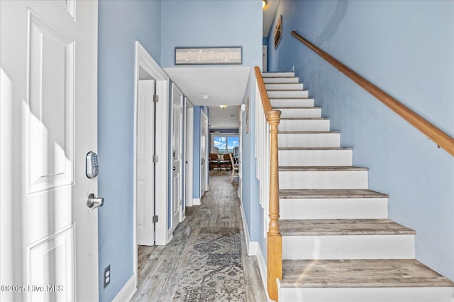 stairway featuring wood-type flooring