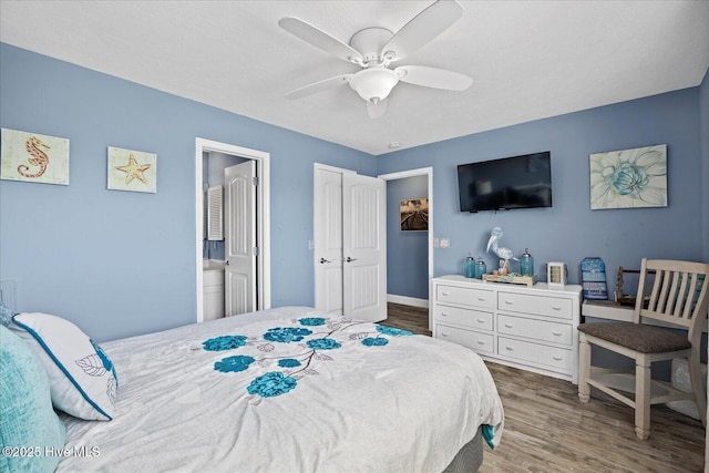 bedroom with ceiling fan, a closet, ensuite bathroom, and hardwood / wood-style flooring