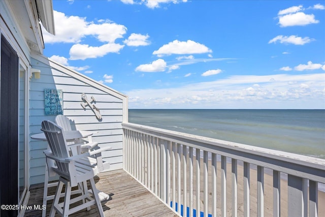 balcony with a view of the beach and a water view