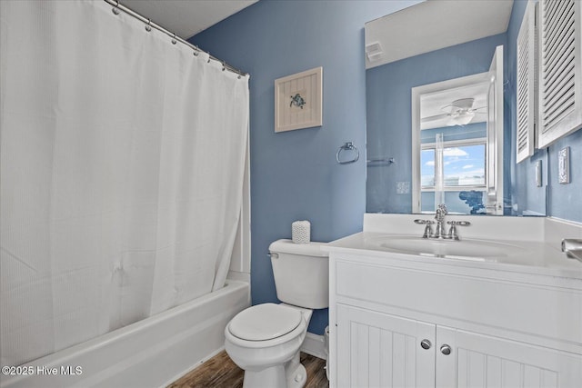 full bathroom featuring hardwood / wood-style floors, vanity, ceiling fan, toilet, and shower / bath combo with shower curtain