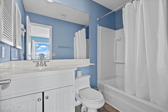 full bathroom with vanity, toilet, wood-type flooring, and shower / tub combo with curtain