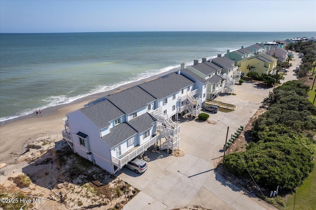 birds eye view of property featuring a water view and a view of the beach