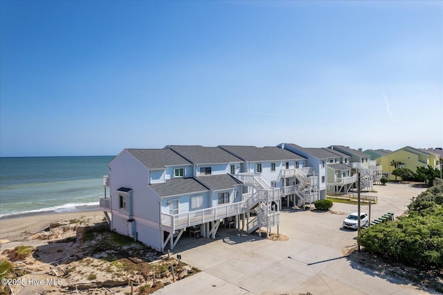 bird's eye view featuring a water view and a beach view