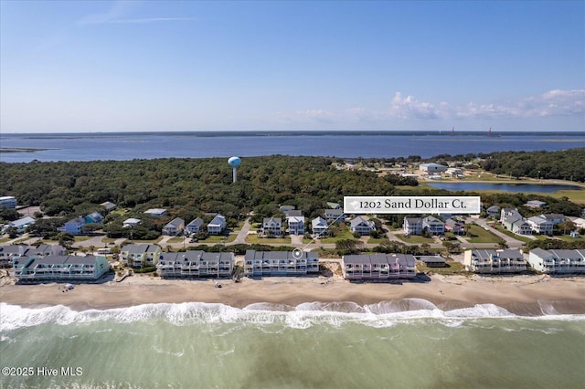 drone / aerial view with a beach view and a water view