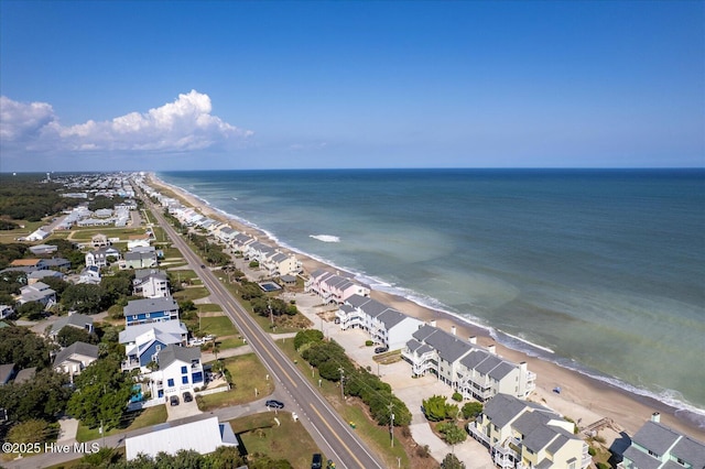 aerial view with a water view and a beach view