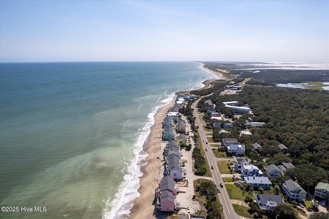 bird's eye view featuring a water view and a beach view