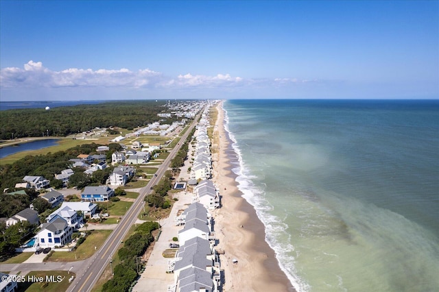 drone / aerial view with a water view and a view of the beach