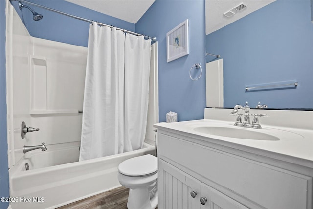 full bathroom with hardwood / wood-style floors, shower / bath combo, a textured ceiling, and toilet