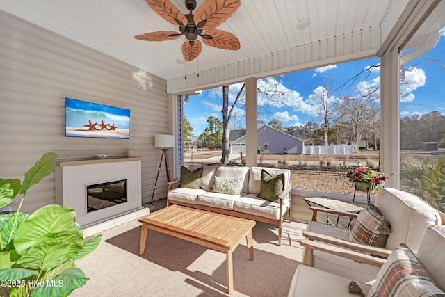 sunroom with ceiling fan and wooden ceiling