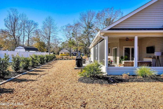 view of yard with ceiling fan and a patio