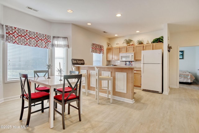 dining room with light hardwood / wood-style flooring