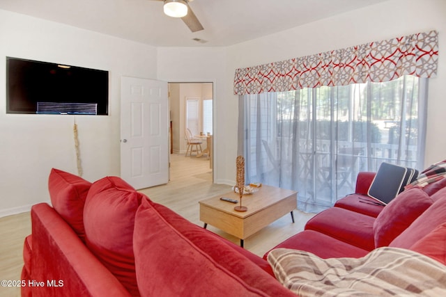 living room featuring ceiling fan and light hardwood / wood-style floors