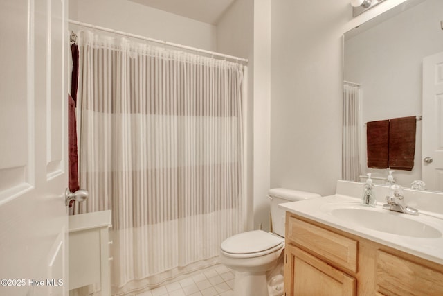 bathroom featuring tile patterned flooring, vanity, and toilet