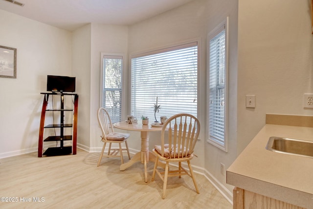 living area featuring hardwood / wood-style flooring and sink