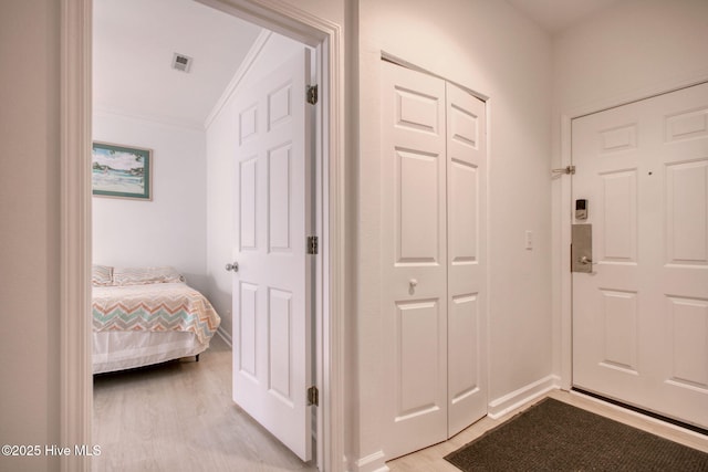 interior space with light wood-type flooring and ornamental molding