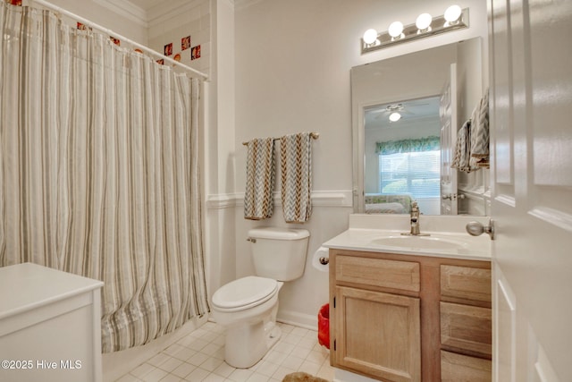 bathroom with vanity, crown molding, tile patterned flooring, toilet, and walk in shower