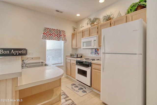 kitchen featuring decorative backsplash, white appliances, sink, light brown cabinets, and light hardwood / wood-style flooring