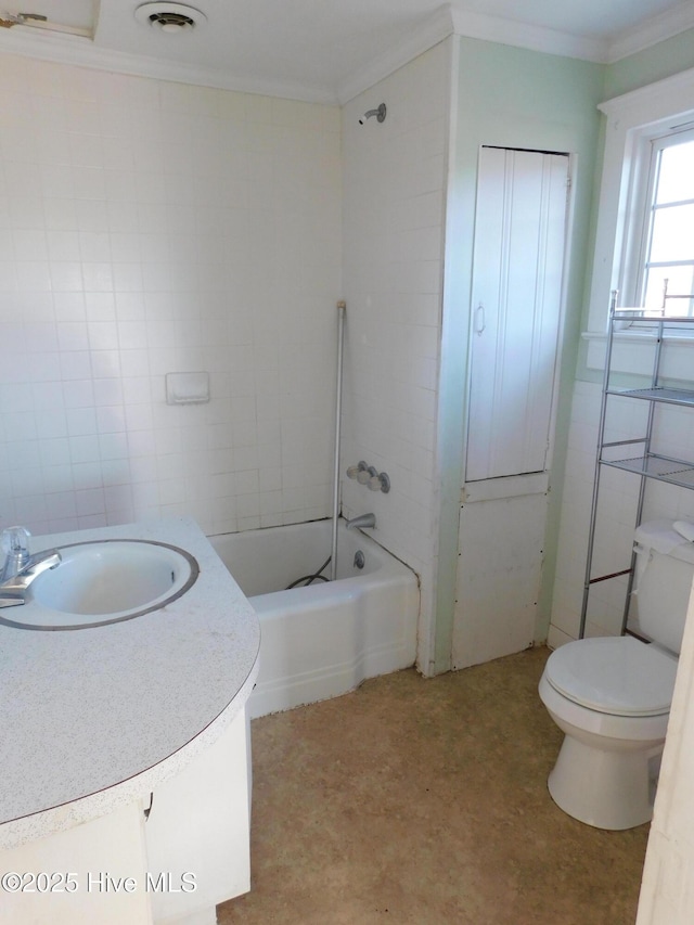 full bathroom with vanity, toilet, tile walls, and ornamental molding