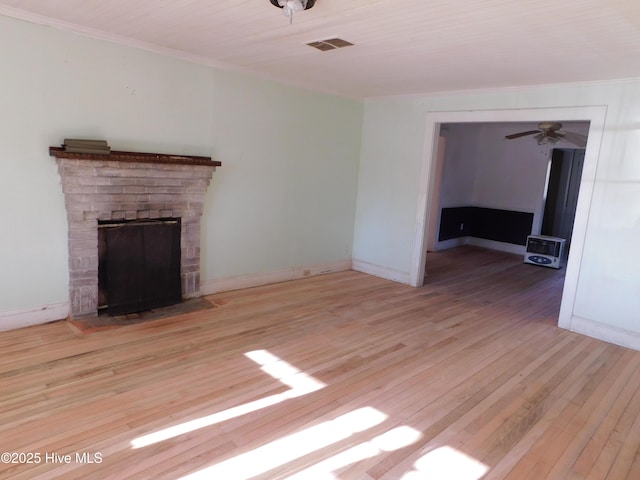 unfurnished living room featuring ceiling fan, a fireplace, and light hardwood / wood-style floors