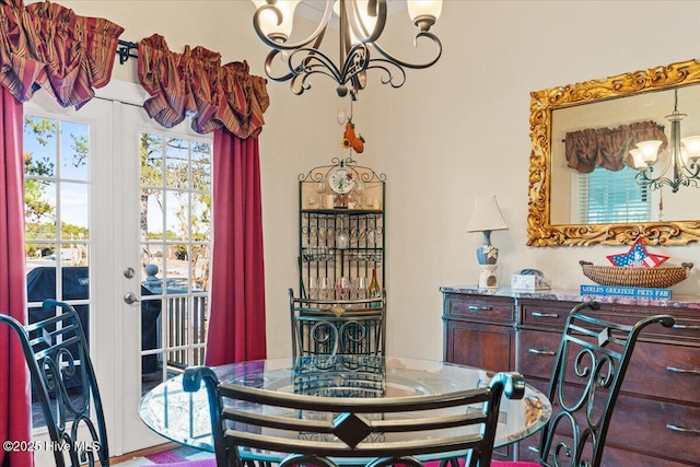 dining room with a notable chandelier and french doors