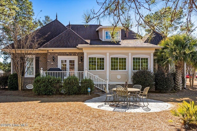 rear view of property featuring a patio and french doors