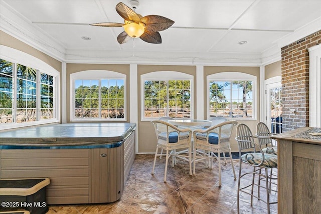 sunroom featuring ceiling fan