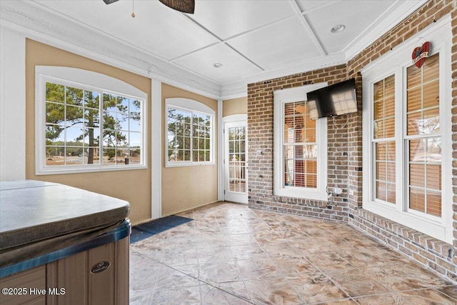 sunroom with coffered ceiling and ceiling fan