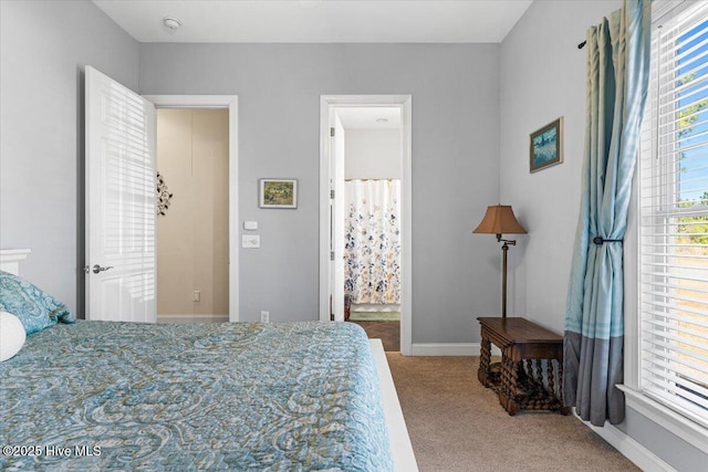 carpeted bedroom featuring ensuite bathroom