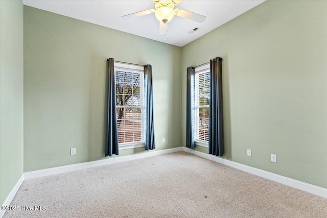 carpeted empty room featuring ceiling fan